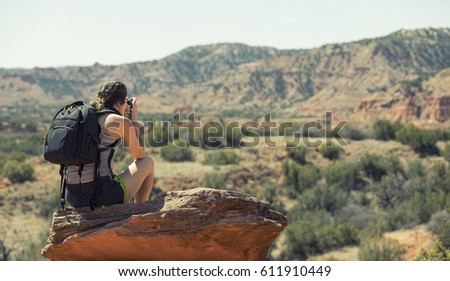 Female Backpacker Taking Photograph of Canyon