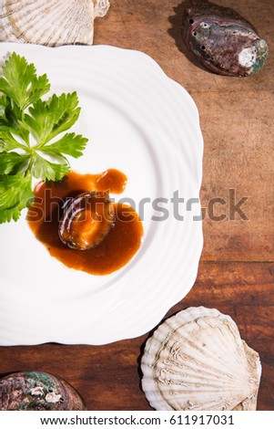 Vertical shooting sauce Abalone in white plate.