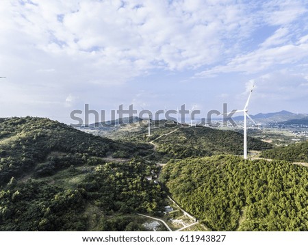Aerial photography bird-eye view of Eco-environmentally friendly power generation of power turbines of green energy on the top of the hill