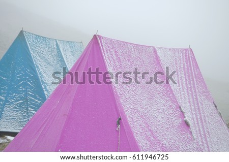 Snow covered tents in the Himalayan mountain