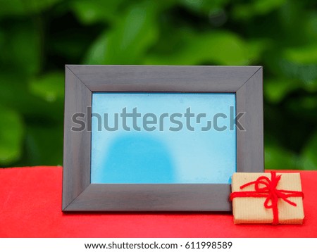 photo frame with gift on red background