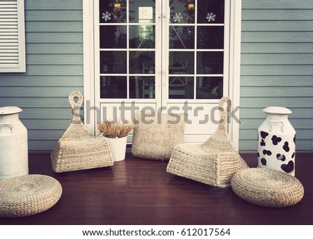 door on blue wooden wall with rattan furniture