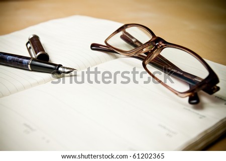 Fountain pen glasses and calendar in composition in color