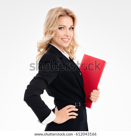 Portrait of young happy smiling businesswoman with red folder, on grey background
