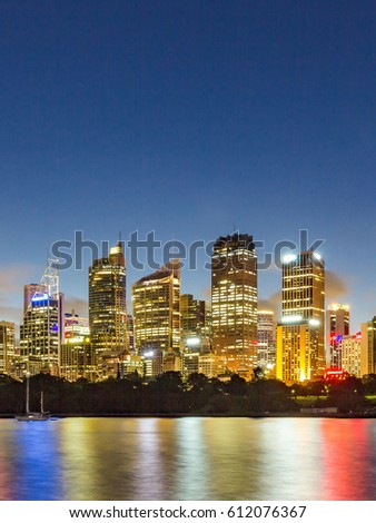 Sydney Skyline, Sydney Landmark, Sydney Tower and Sydney City CBD at night with blue sky blur cloud long exposure and Reflection From circular quay from Mrs Macquarie's Chair in Summer, Australia 