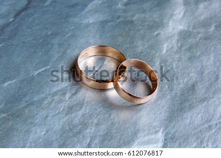 macro of wedding rings on dark wood in day light