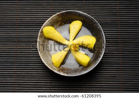 stock image of the spa concept-yellow orchid flower floating in wooden bowl