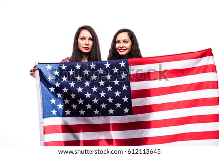 Happy twins holding american flag isolated on white