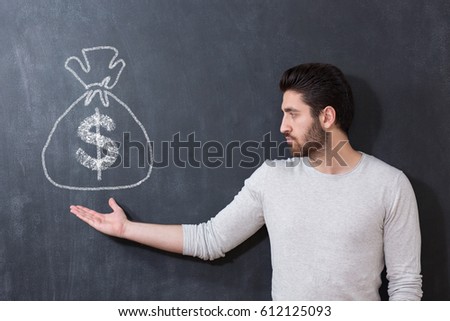 Man holding a bag of money drawn on chalkboard.