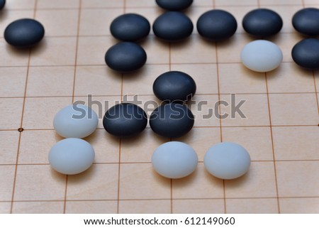 GO game. GO is an abstract strategy board game for two players, in which the aim is to surround more territory than the opponent.