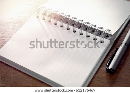 Open a blank notebook and pen on the table , pen and empty notepad or notebook , Blank notebook with pen on wooden table