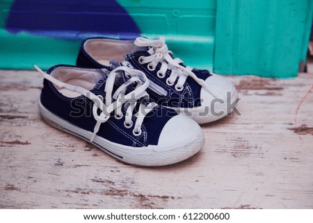 kids sport shoes on wooden background