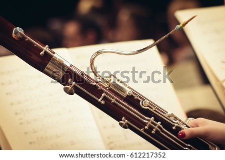 Musician holding basson on concert. Music background. Royalty-Free Stock Photo #612217352