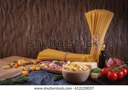 Pasta,  tomatoes, salami and cheese on the table