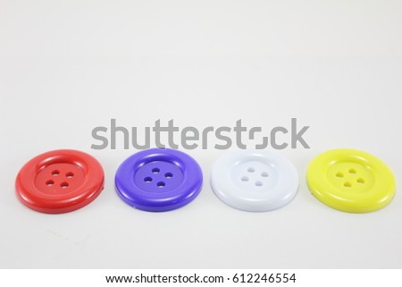 Multi-colored button,stud,buckle on white background.