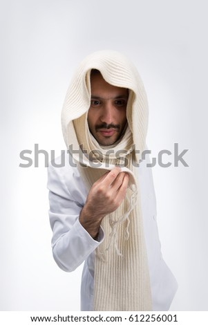 A Syrian guy with a mustache in a white suit. Corrects the scarf with the right hand . On a white background