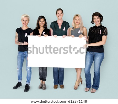 Group of women with pink ribbon and holding blank banner for breast cancer awareness