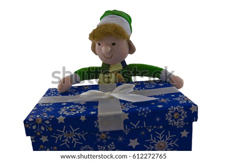 Toy elf with a Christmas present. Handmade toy.
