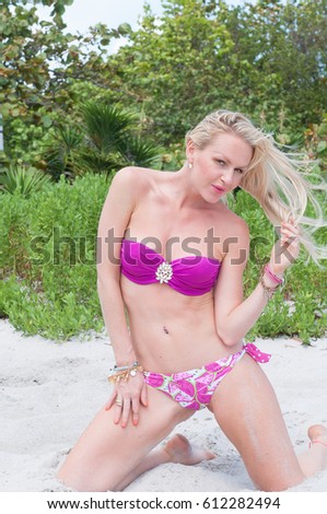 Blonde haired model posing near the Cape Florida Lighthouse on Key Biscayne.