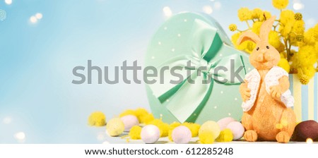 Blooming mimosa branches with easter eggs