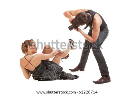 Young adult female Caucasian model being photographed in studio by young  male photographer.