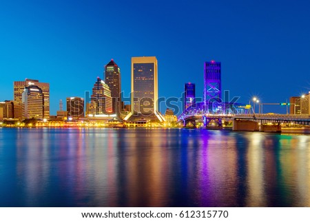 Skyline of downtown Jacksonville, Florida, USA with the St. Johns River at twilight.