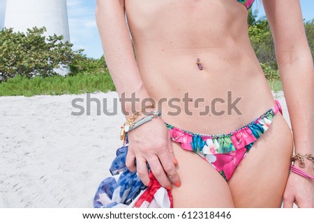 Image of a model's stomach and bikini bottom.
