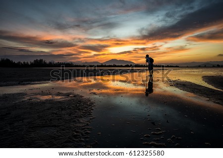 The Landscape photographer was taking a view of calm sea and sunrise twilight sky.At Morning time.Loaction is in Ranong.Thailand