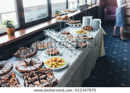 Beautifully served banquet table with cold snacks and pastries