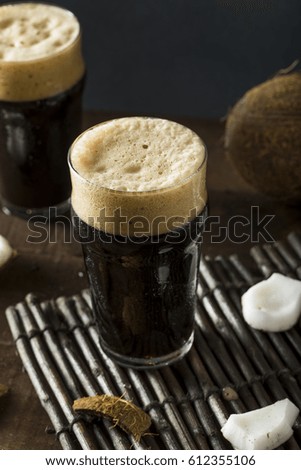Refreshing Cold Dark Coconut Beer in a Pint Glass