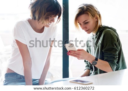 Two female friends are watching photos on the screen of a mobile phone. Two young entrepreuner are typing email to the customer. Student girls are having rest in the university campus.