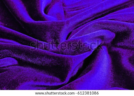 Velvet dress material cloth texture pattern. 
tailoring stitching concept. Shiny beautiful fashion fabric. Shiny clothing material sample.Creased fabric. Purple blue.
