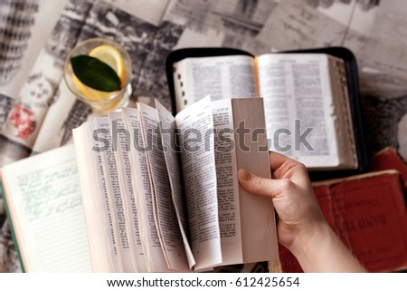 Girl holding a Bible. Concept for faith, spirituality and religion. Young woman reading a Bible.