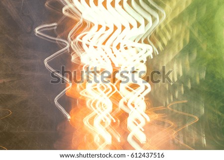 Multicolor abstract soft light painting of background of light trails with circular rotation in a building by long exposure