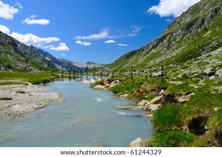 River flowing in glacial valley in italian Alps