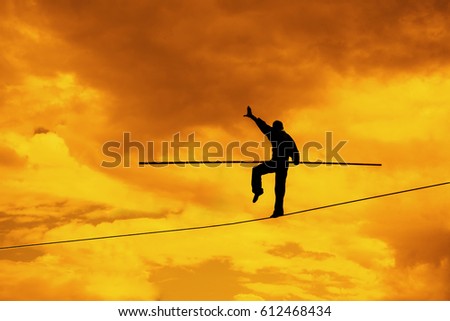 Wandering tightrope walker playing on sky background. Silhouette of Equilibrist businessman with pole on rope. idea, sign, symbol, concept of risk, peril, danger and balance in business Royalty-Free Stock Photo #612468434