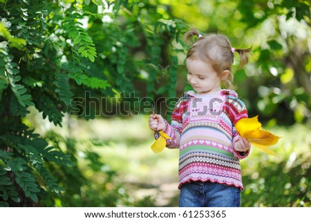 Adorable toddler in early autumn park