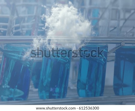 Double exposure of test tube, medical research.