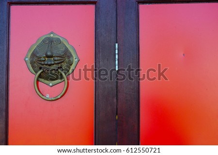 Red chinese door with a lion/dragon head. (china)