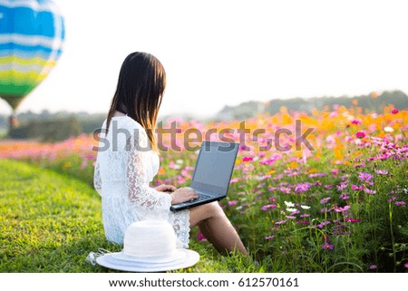 working woman using laptop at flower garden, businessman typing on notebook, concept of businessman