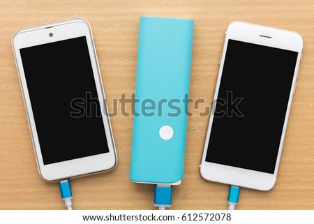 Smartphone is charging with power bank in top view