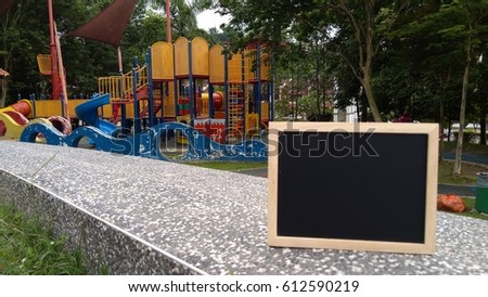 blackboard on playground background ideal for advertisement purpose. low light, selective focus, blur image   