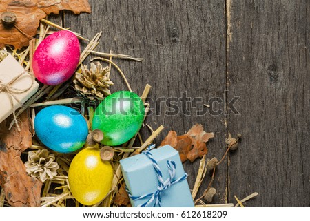 Easter background with colorful chicken eggs on old gray boards. Place for the text.