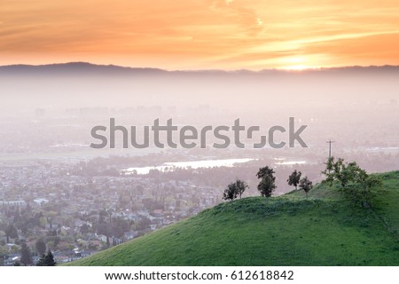 Breathtaking Silicon Valley Sunset. Santa Clara Valley in Haze with green hill and sunset skies from Mount Hamilton.