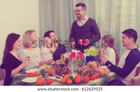 Person celebrating jubilee with big family at festive table