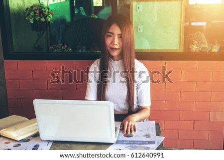 Teenage freelance working business on laptop. Selective focus and soft flare filter.