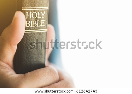 woman hand praying on the holy bible in the morning.teenager woman hand with Bible and praying.Concept for faith, spirituality and religion.