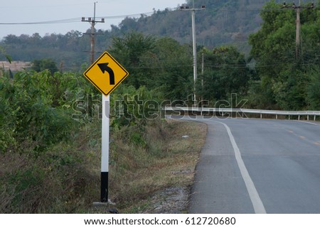 left curved road sign with rural road