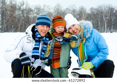 happy young parents going ice skating with their son