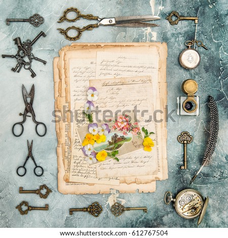 Old letters, postcard, pansy flowers and antique objects. Flat lay